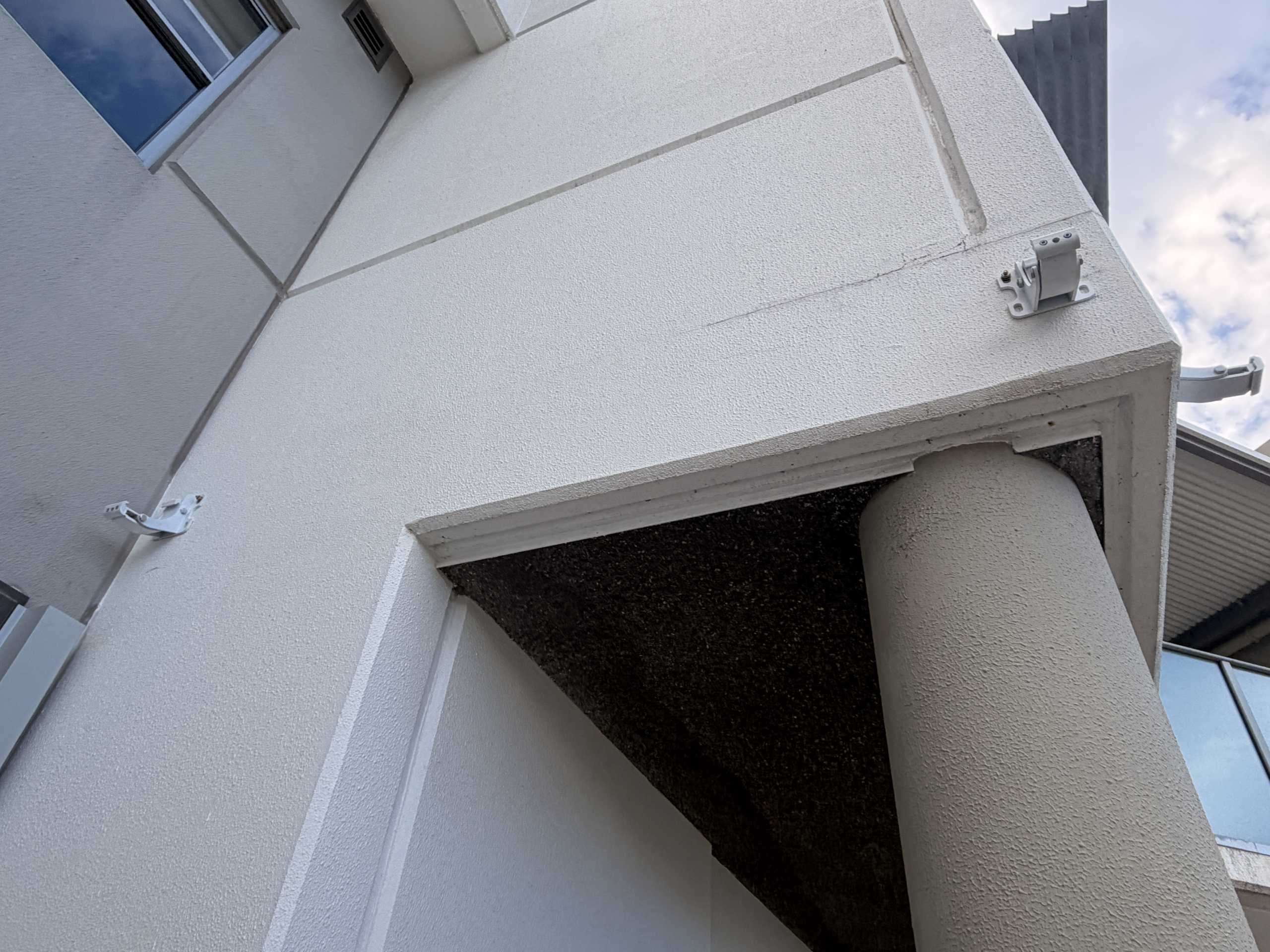 Two awning brackets mounted on the Helensvale office wall
